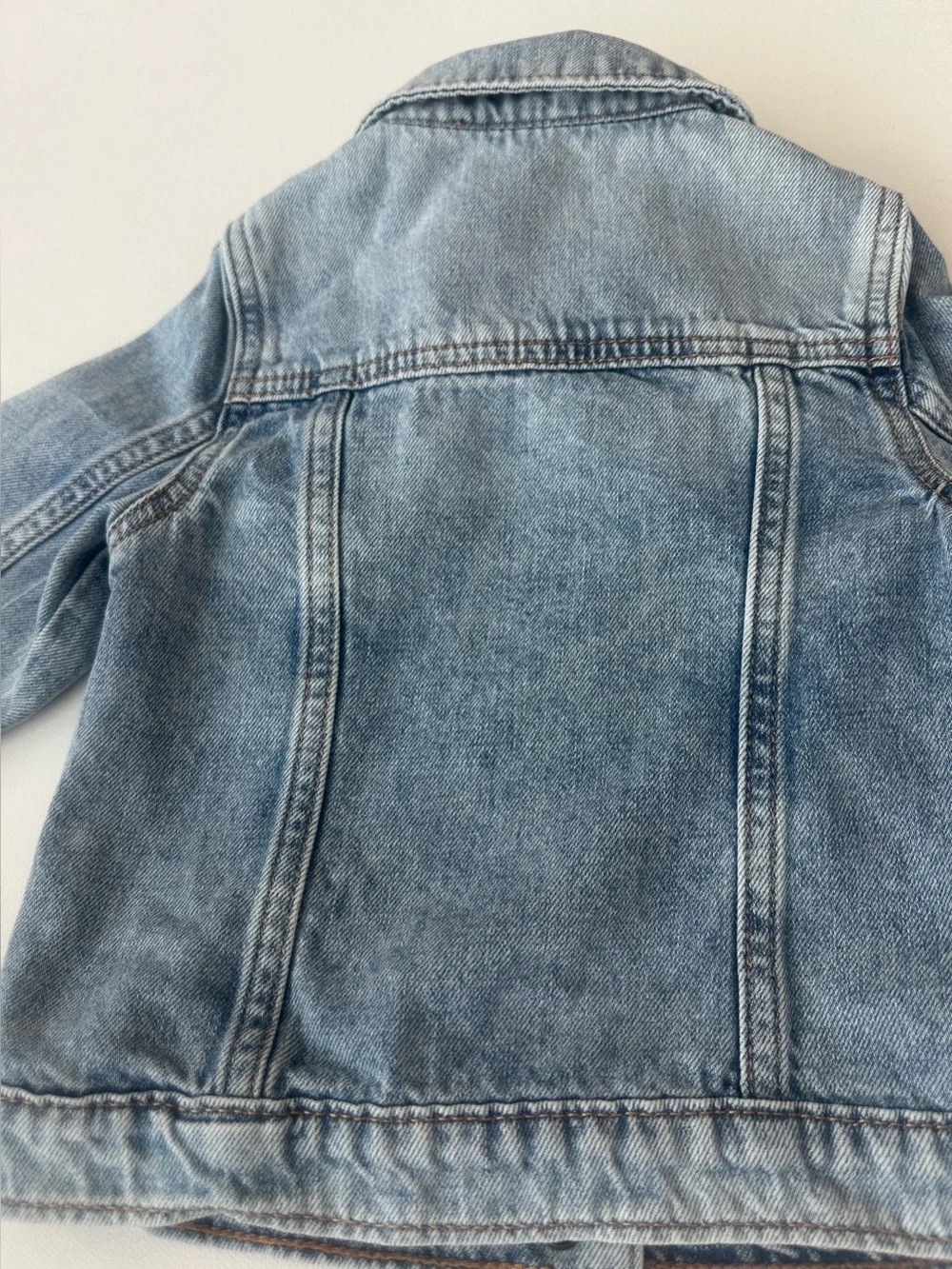Gap girl’s Icon Denim Jacket. with distressed detailing at the chest.  Size 4T.